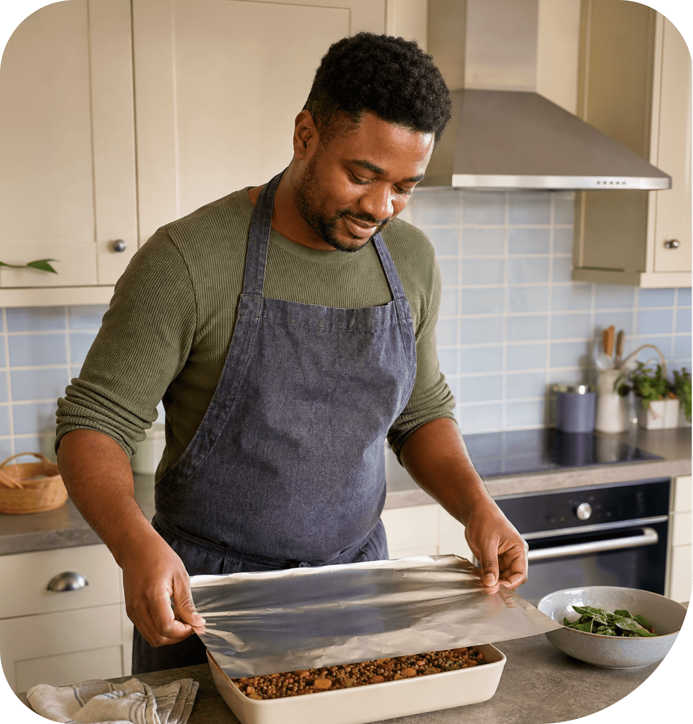 A cook holding a freshly baked dish
