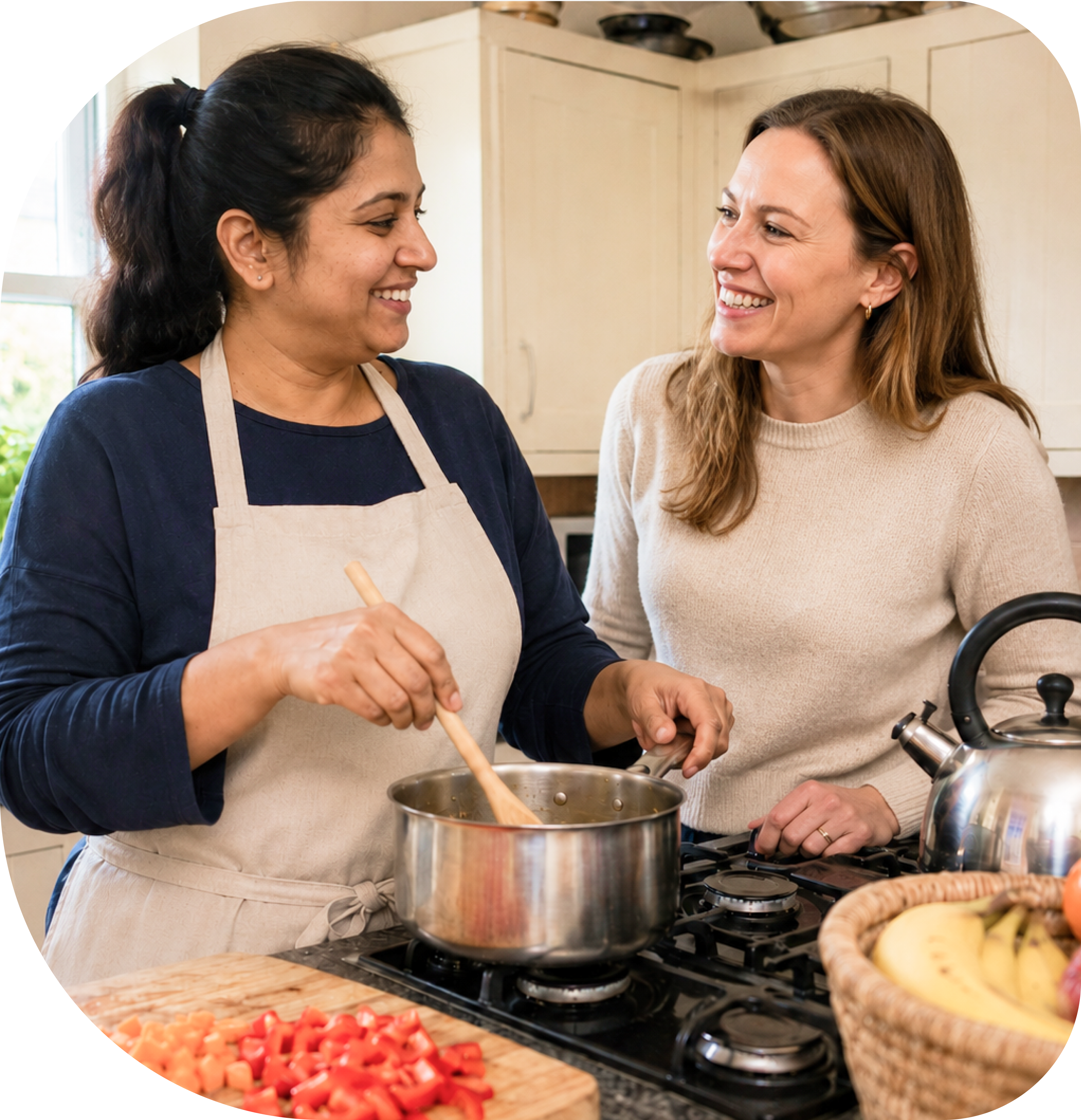 Two cooks chatting and cooking together in a home kitchen